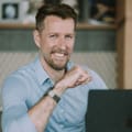 Keith Walker smiling infront of a laptop