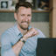 Keith Walker smiling infront of a laptop